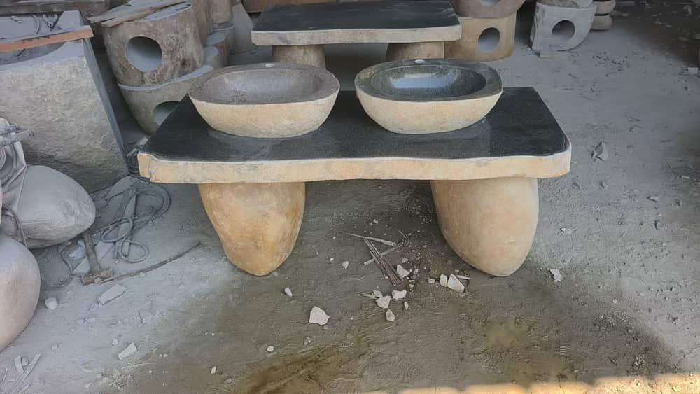 Custom stone counter with multiple vessel basins and stone supports