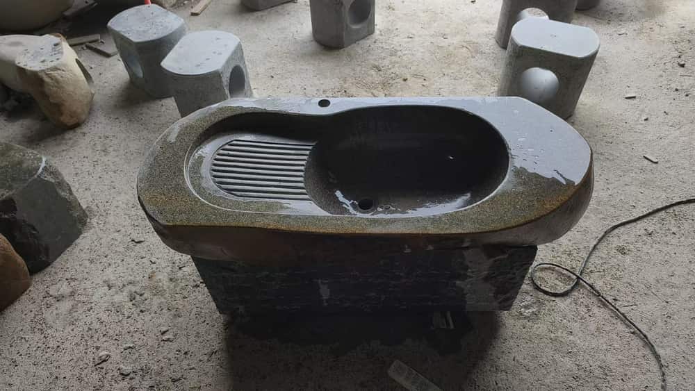 Dark stone wash basin with integrated drainboard