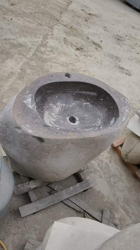 Round light grey natural stone wash basin with central drain