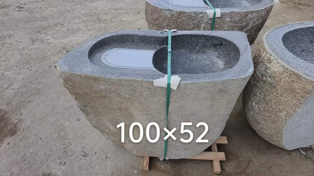 Rectangular natural stone wash basin secured for handling with dimension marking