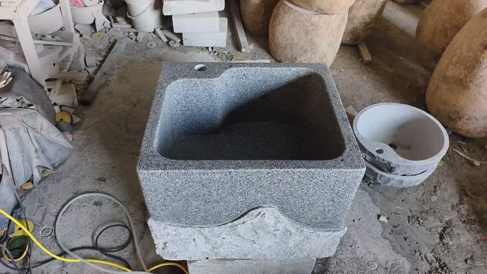 Square stone wash basin with deep bowl photographed in the workshop