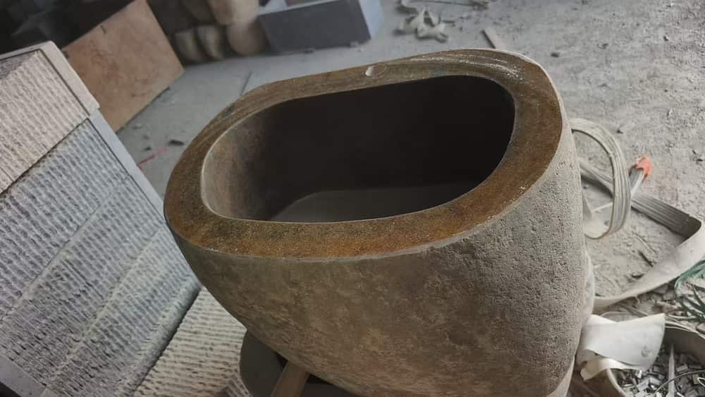 Oval natural stone wash basin photographed in the workshop