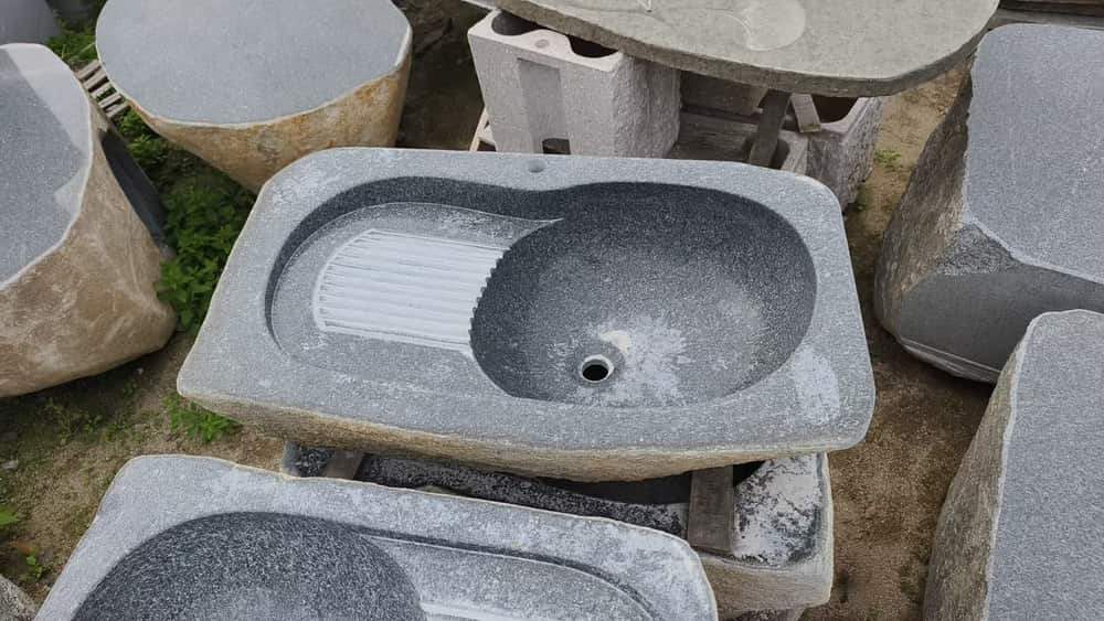 Rectangular stone wash basin with an integrated drainboard and drain opening